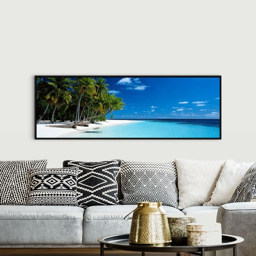 A bohemian room featuring Panoramic photograph of a vibrant beach on a sunny day in Maldives.  The tall palm trees run acro...