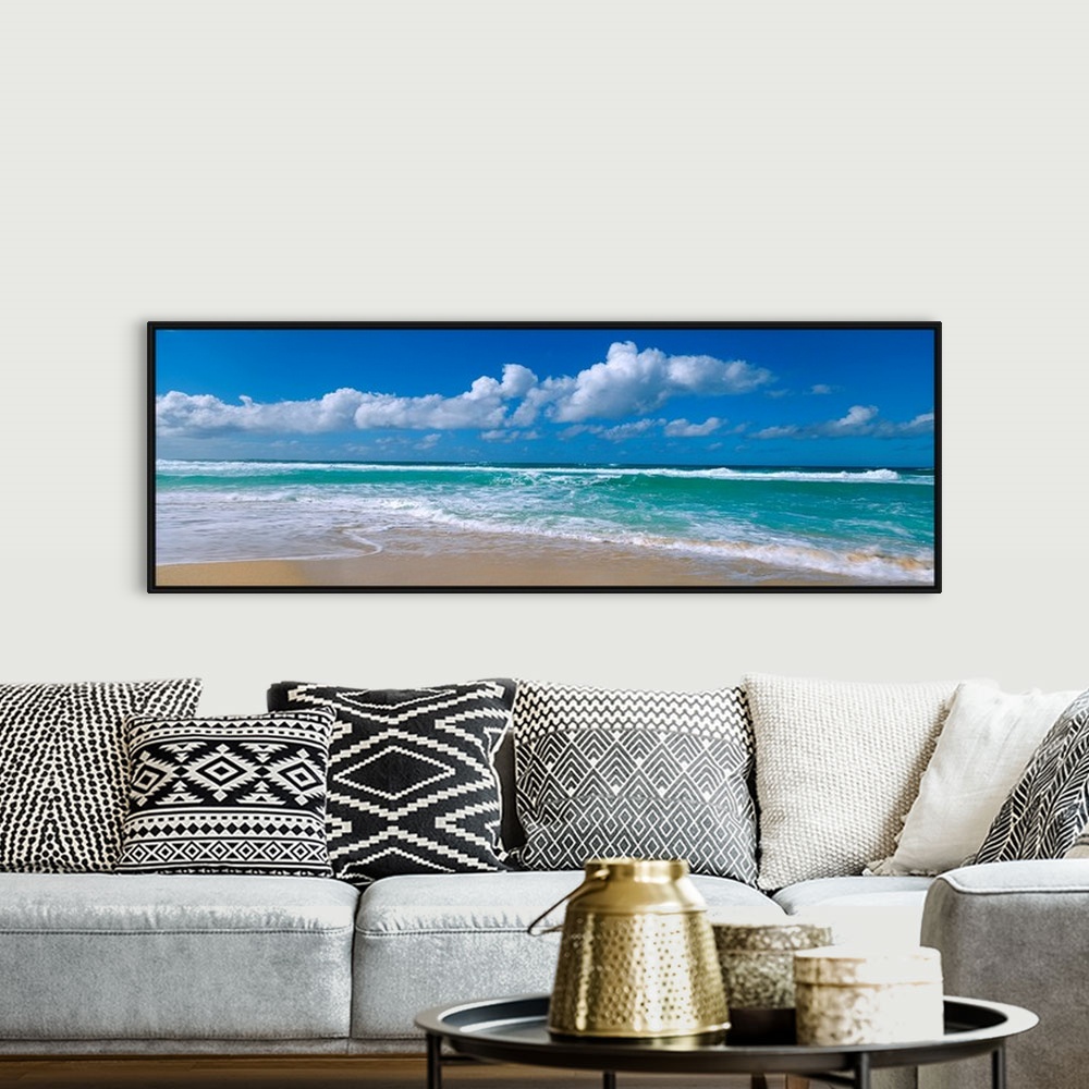 A bohemian room featuring Panoramic view of a Hawaiian beach where waves are washing up on the shore while the wind blows c...