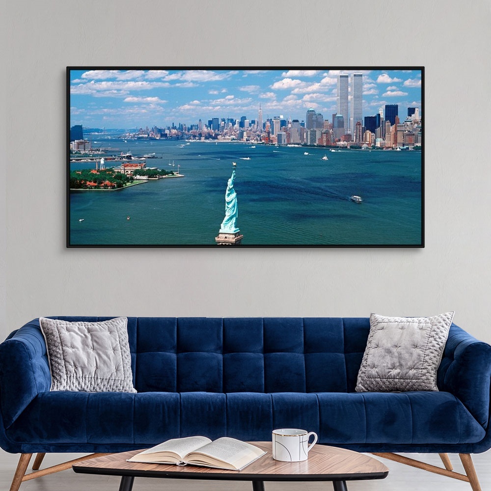 A modern room featuring Panoramic wall art of Manhattan, Ellis Isle, and Hudson River photographed from south of the Stat...
