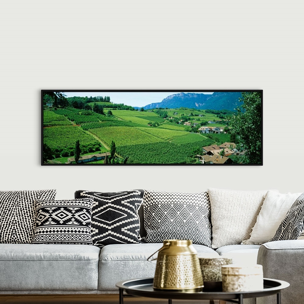 A bohemian room featuring Panoramic photograph displays the rolling countryside of a European country scattered with houses...
