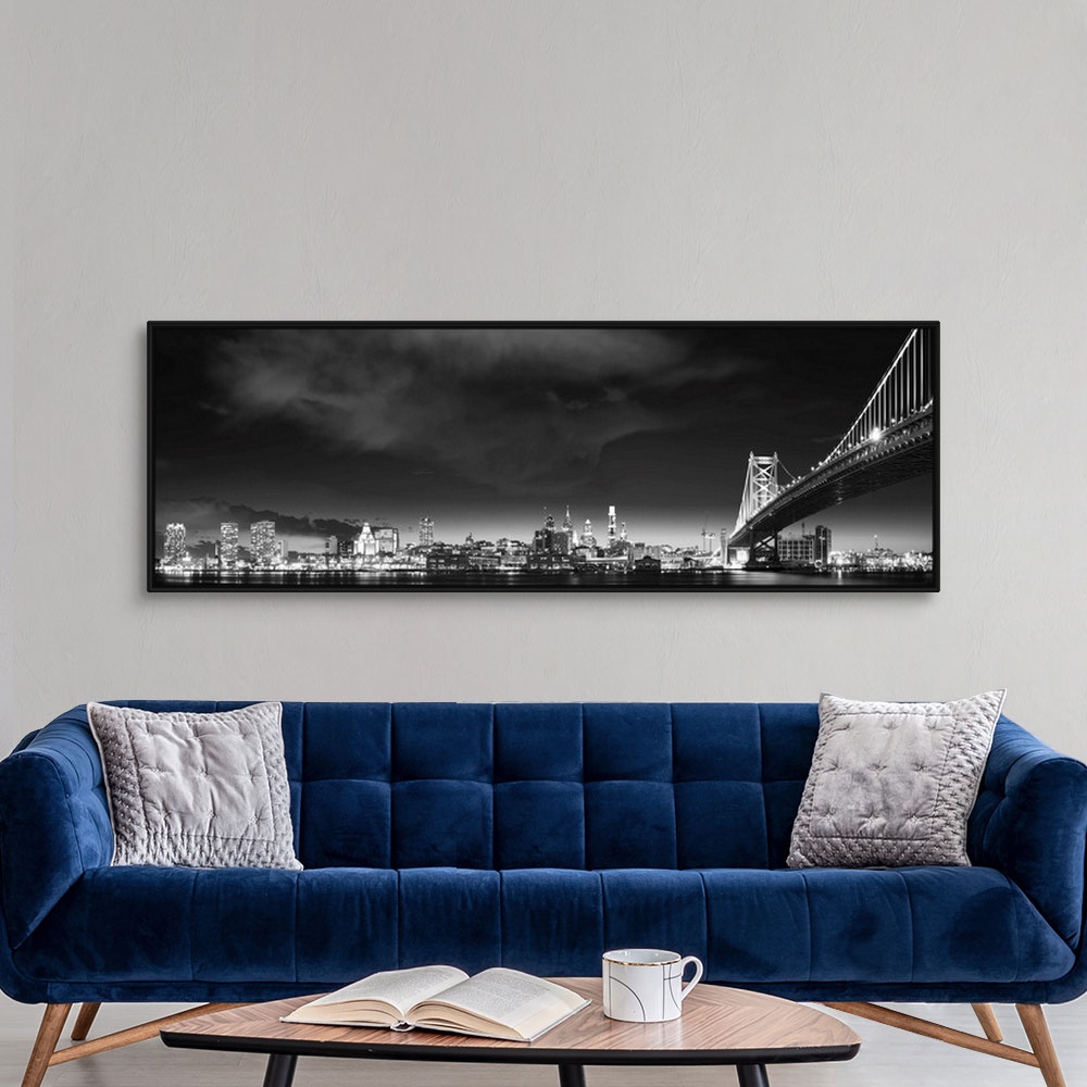A modern room featuring Panoramic photo of the Philadelphia city skyline at night, with the Benjamin Franklin Bridge on t...