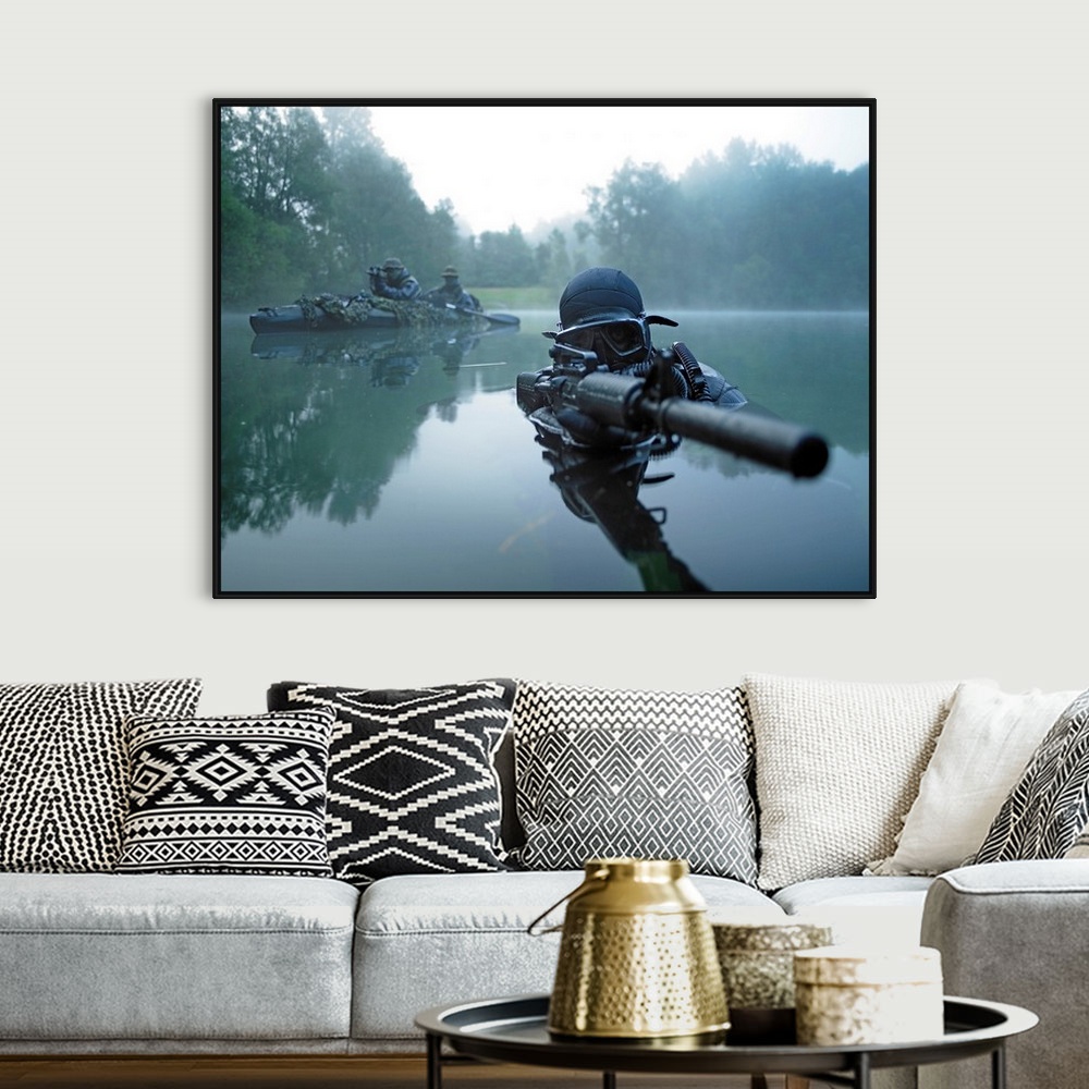 A bohemian room featuring Landscape photograph of a special operations forces combat diver just above foggy water,  armed w...