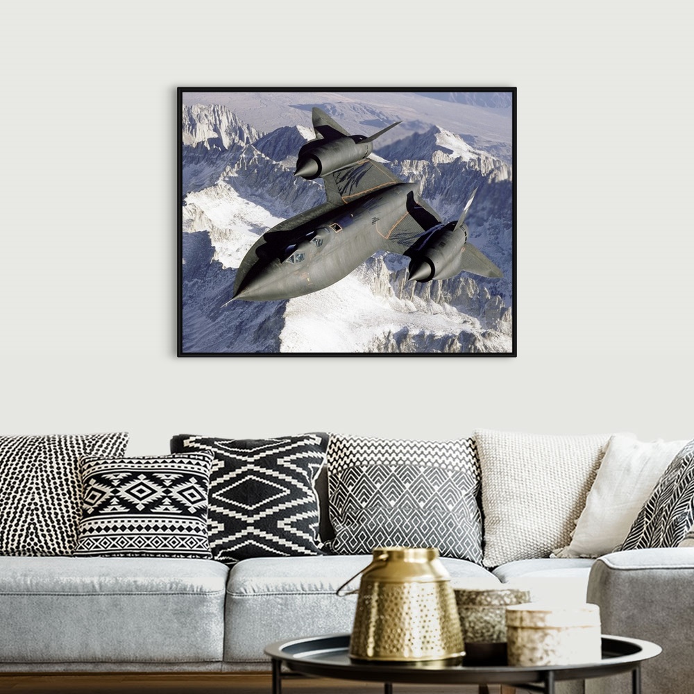 A bohemian room featuring A Lockheed SR-71 Blackbird spy plane flies over a mountain range as the sun shines down.