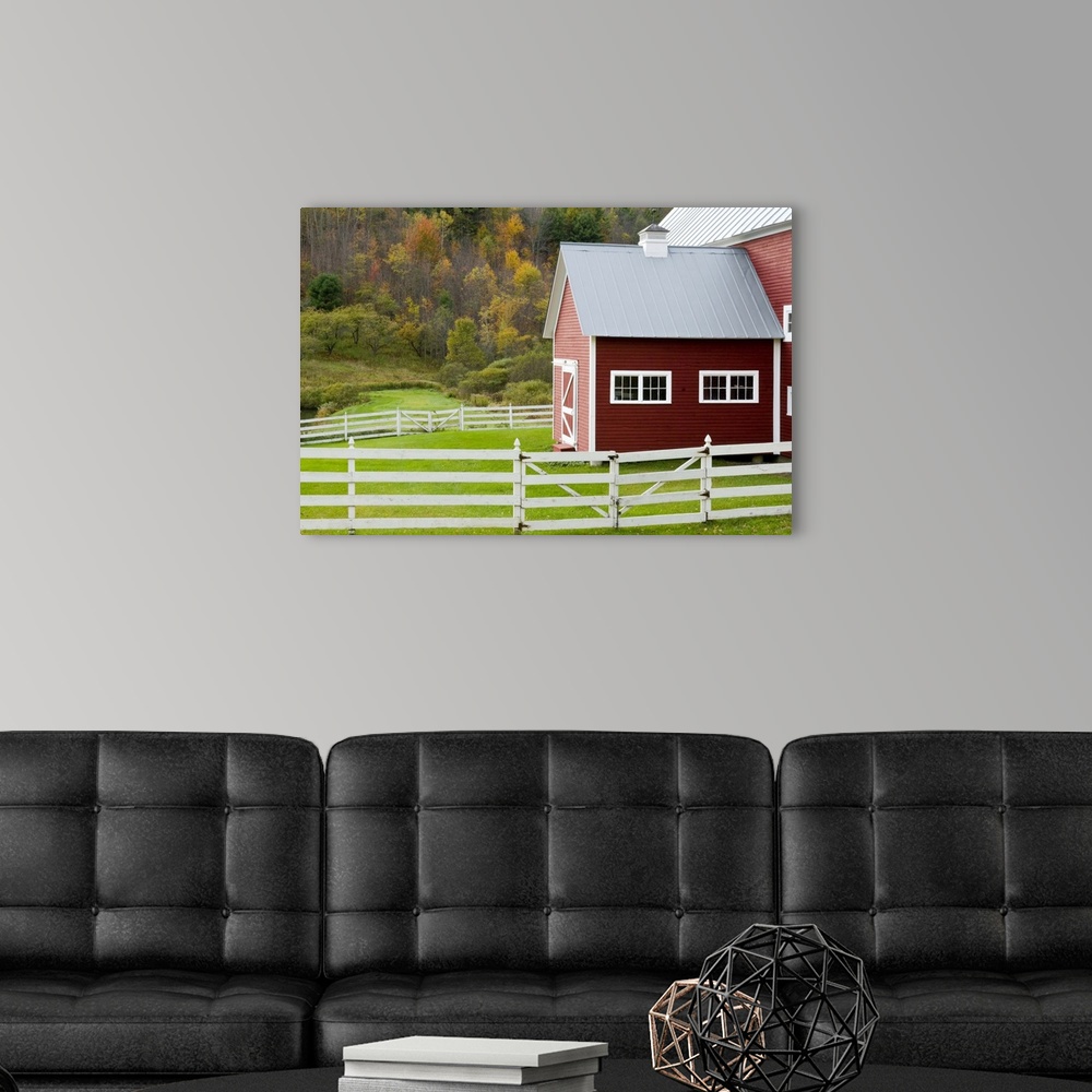 Classic New England farm with red barn and white fence